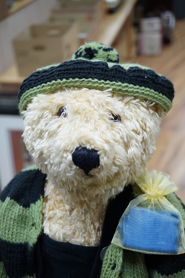 A Steiff artificial silk Teddy bear, (5650.2), jointed blonde body, stitched snout and glass eyes, button in ear, with related book and papers, bear 50cm